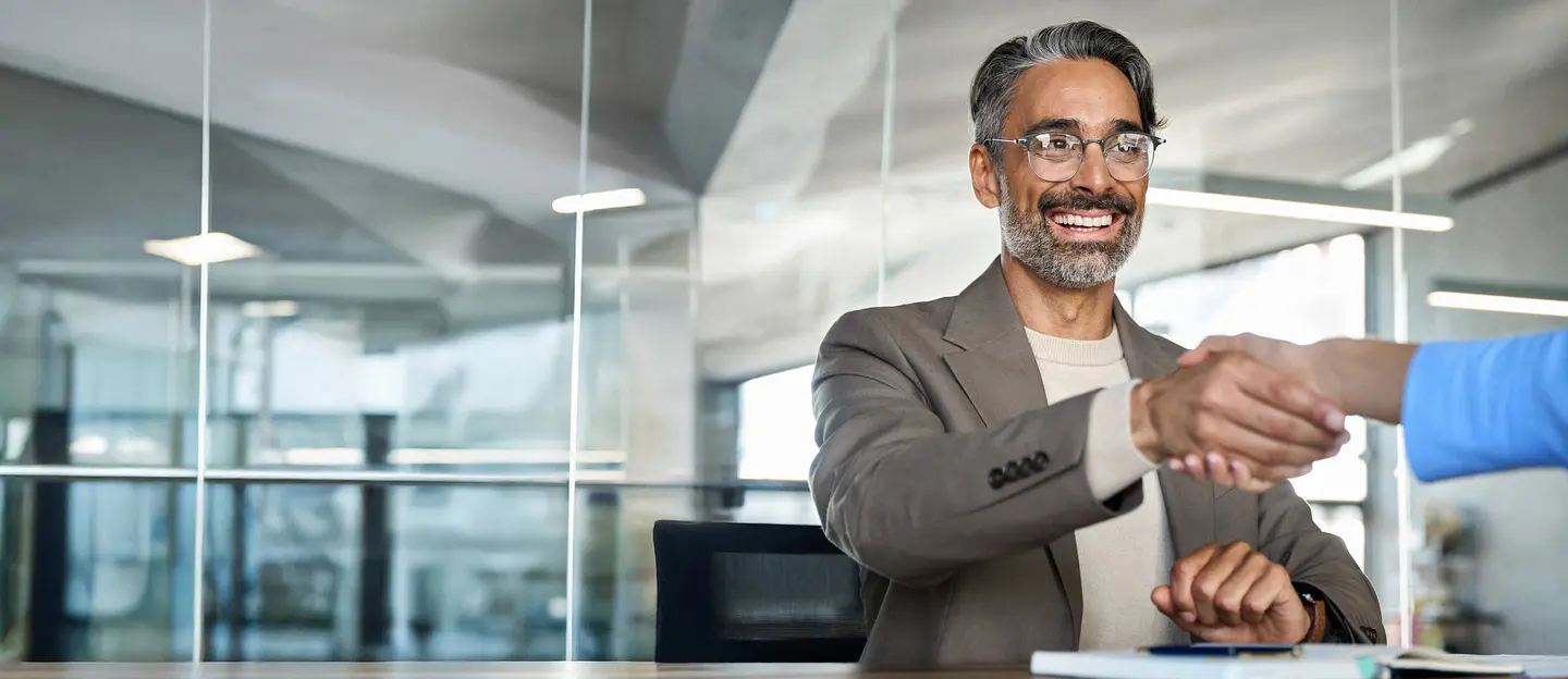 Man with beard shaking hands looking for an open position at northmarq