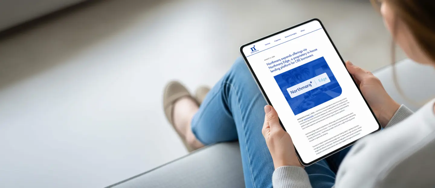 person looking at a table showing the press release for the new northmarq edge service