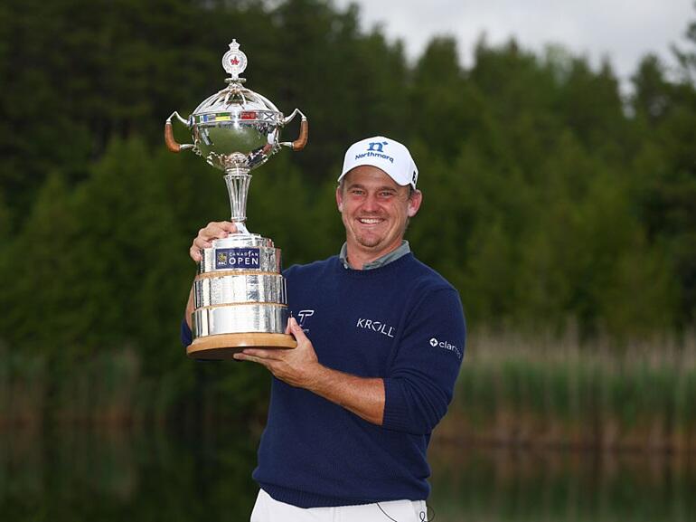 Image of Bud Cauley holding trophy.