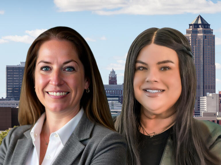 Northmarq's Lanie Beck and Bianca Farrington in front of a downtown skyline