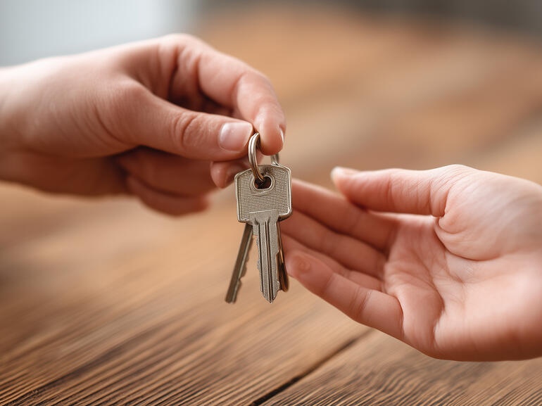 Seller handing building keys over to the buyer
