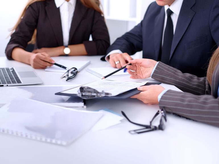 Group of business people at a meeting against the background of the office to discuss a reverse 1031 exchange