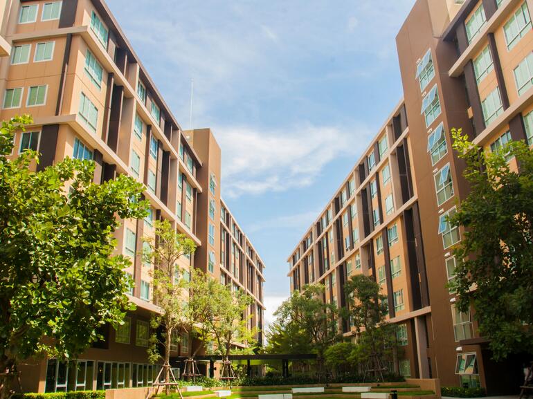 Corridor view between two multi-story off campus student housing apartments