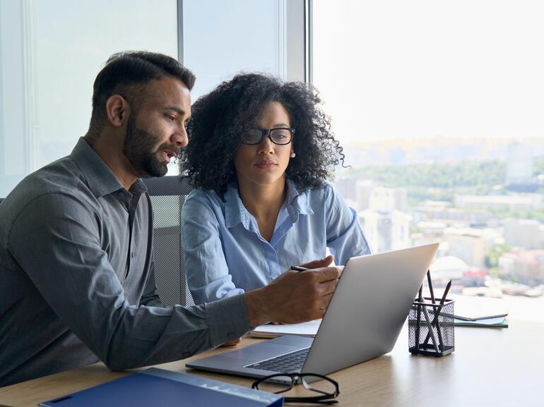 Man and woman looking at computer