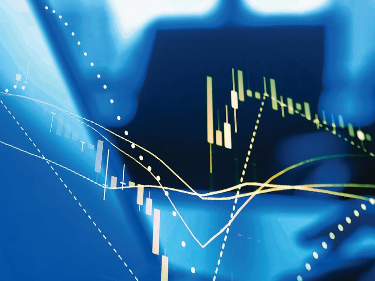 Typing on laptop with graph overlay