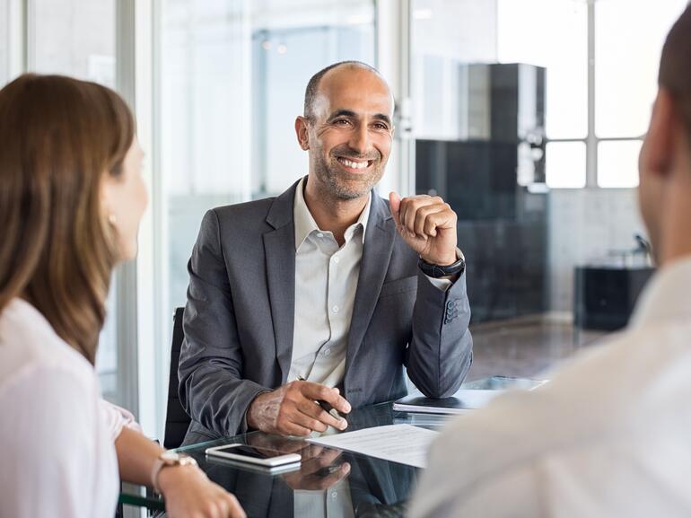 Loan servicing professional smiling at clients