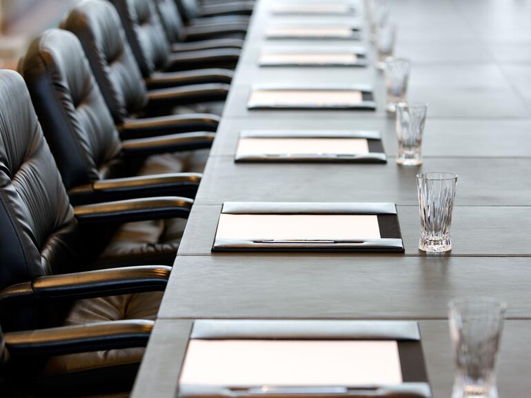 The boardroom table is set for the Annual General Meeting