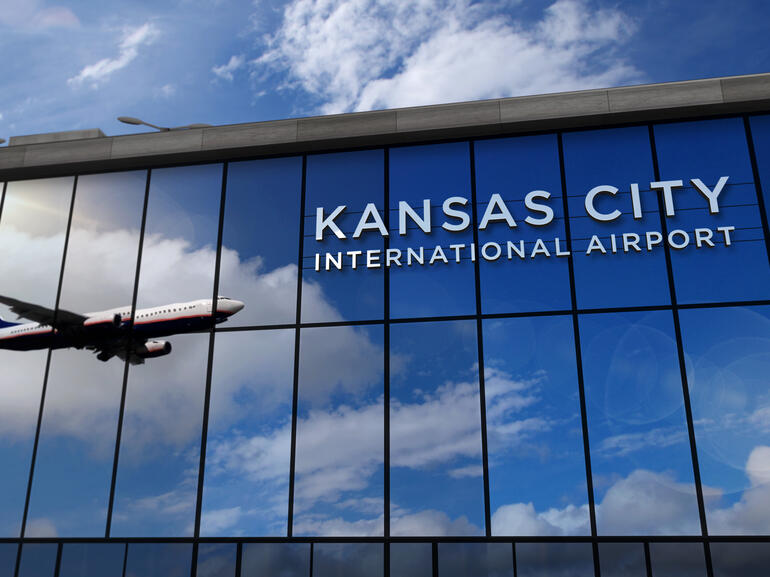 Kansas City International Airport terminal with reflection of airplane