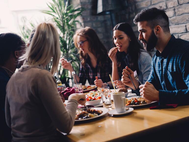 Young professionals eating dinner in a restaurant