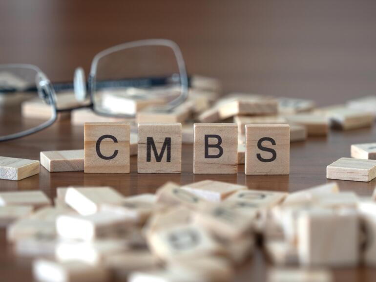 Scrabble tiles spell out CMBS