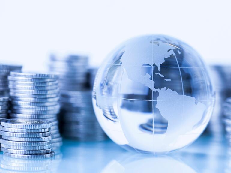 Stacks of coins and globe