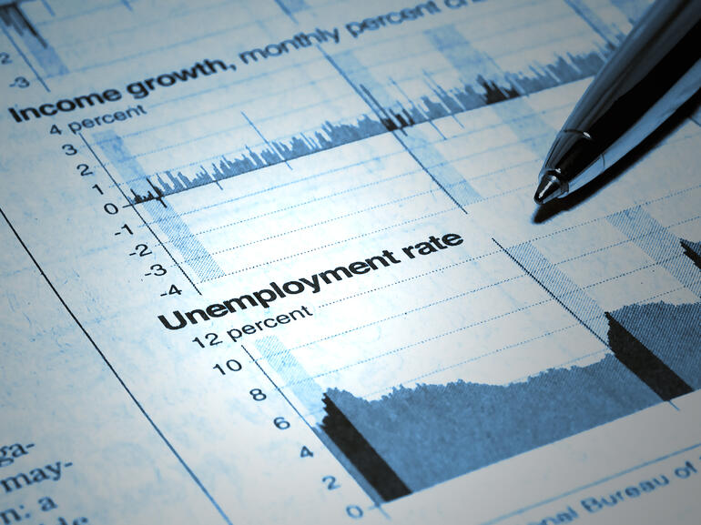 Pen pointing to unemployment graph