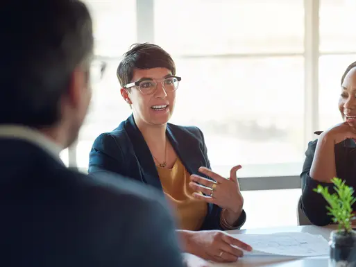 Talking, people and businesswoman in meeting, discussion or group conversation for investment. Teamwork, paperwork or financial investors planning for strategy, feedback report or project funding