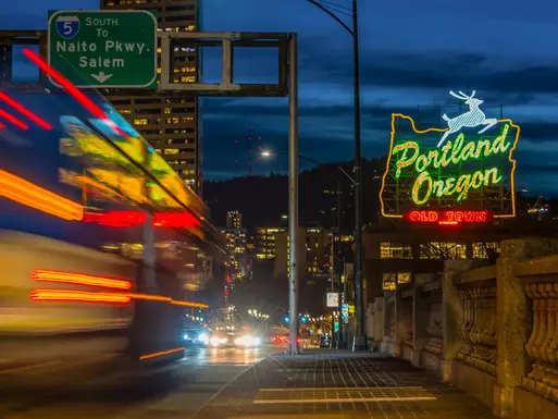 Skyline of Portland, Oregon at night with neon signs