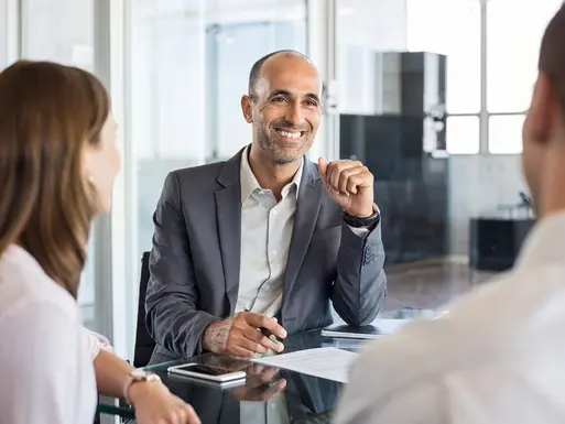 Loan servicing professional smiling at clients