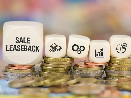Blocks on stacks of coins that spell out sale leaseback