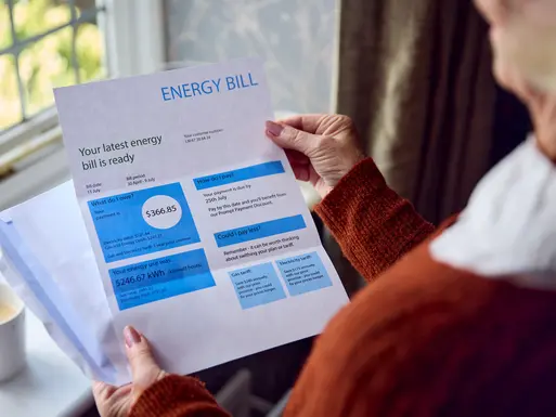 Close Up Of Senior Woman Opening Energy Bill Concerned About Cost Of Living Energy Crisis 