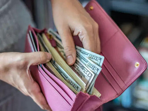 Person getting cash out a wallet